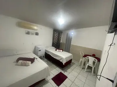 Uma cama ou camas num quarto em Pousada Carimbó