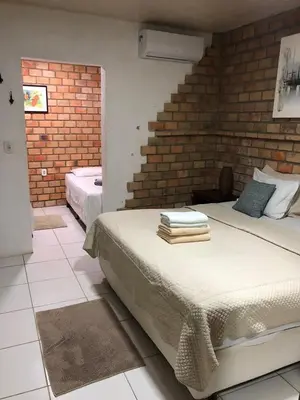 Uma cama ou camas num quarto em Pousada Vila Canoa