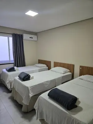 Uma cama ou camas num quarto em Residencial Amora