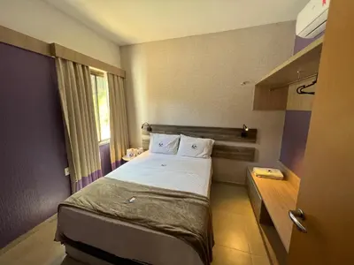 Uma cama ou camas num quarto em Cidade Jardim Apart