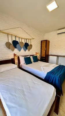Uma cama ou camas num quarto em Suítes Bosque de Flecheiras