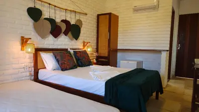 Uma cama ou camas num quarto em Suítes Bosque de Flecheiras